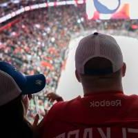 Alumni looking out at the ice